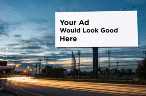 Nighttime Billboard with the words 'Your Ad Would Look Good Here' on it