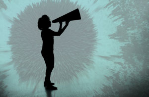 Silhouette of a woman holding a megaphone