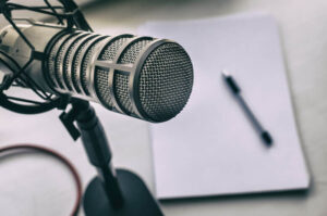 Podcast microphone and notebook