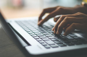 fingers typing on a computer